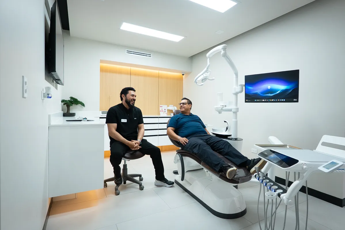 A Let’s Smile Dentistry team member welcoming a patient in a treatment room